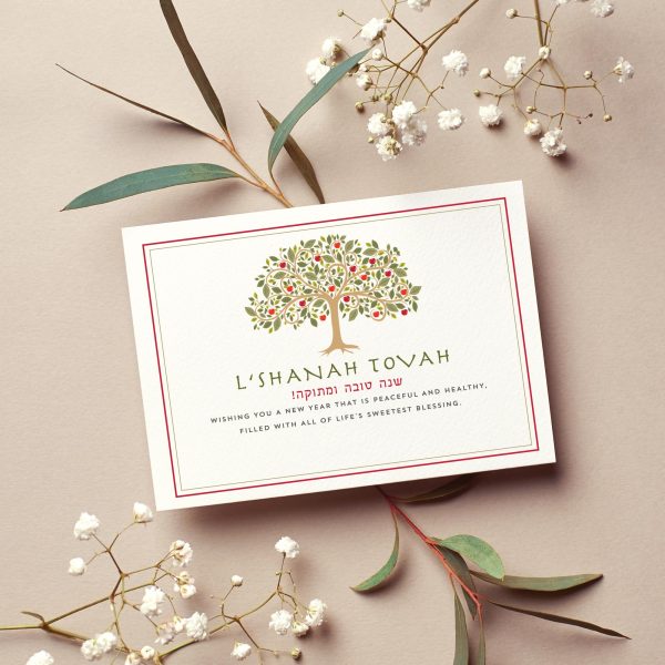Rosh Hashanah greeting card with a Tree of Life apple tree illustration, "L'Shanah Tovah" greeting, and Hebrew blessing Shanah Tovah U'Metukah on an ivory background with red and gold border.