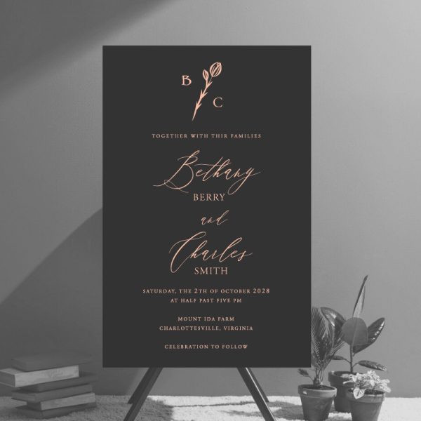 A gorgeous modern wedding invitation with your personalized monogram surrounded by a simple flower. The design includes a clean layout for your wedding details which are written in a mix of modern script fonts.