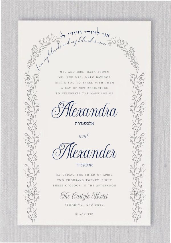 The Arched Floral Chuppah Jewish Wedding Invitations showcase etchings of trailing vines arching over the top of the Chuppah. The navy-inspired design features the phrase 'I am my beloved's, and my beloved is mine' in both Hebrew and English. The names of the bride and groom are elegantly presented in fancy type beneath the Hebrew names.