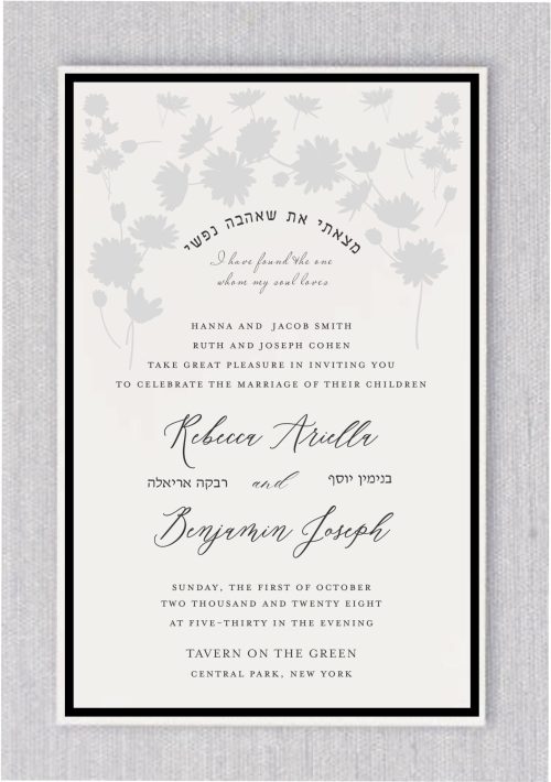 A beautiful and beloved floral design in a very light shade of gray creates an abstract garden of flowers, artistically shaped like a chuppah, placed at the top of the invitation. Beneath this stunning floral arch, the verse from Song of Songs, "I have found the one my soul loves," is written in both Hebrew and English. The Hebrew text is elegantly rendered in an arch, while the English translation appears below it in a refined, classic font. The entire invitation is framed by an elegant black-tie border, adding a touch of sophistication, perfect for a fancy event. The bride and groom's names are prominently displayed in a flowing script font, with their Hebrew names listed underneath in a more formal typeface. The overall design conveys elegance, love, and celebration.