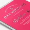 The square shape of the invitation is naturally eye-catching, then pair it with a fresh layout and the modern shine of enhanced raised foil and you have a real jewel of a Bat Mitzvah invitation. The backer creates a sophisticated frame around the entire invitation for a perfect finish.