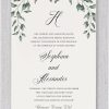 Evergreen Heart Wedding Invitations offer a truly breathtaking and one-of-a-kind design for your special day. The lush, evergreen heart shape gracefully frames the top of the invitation, creating a stunning focal point. Beneath this, the groom’s future initials are elegantly featured, adding a personal touch of tradition. The names of the couple are beautifully arranged in a staggered layout, giving the design a contemporary and artistic flair. This invitation perfectly blends nature-inspired elements with modern sophistication, ensuring that you and your guests are captivated by its timeless beauty and elegance.