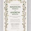 Introducing Golden Glow Wedding Invitations, featuring a border adorned with branches and leaves in shades of gold and hunter green. The names are elegantly highlighted in a modern font, creating a striking contrast.