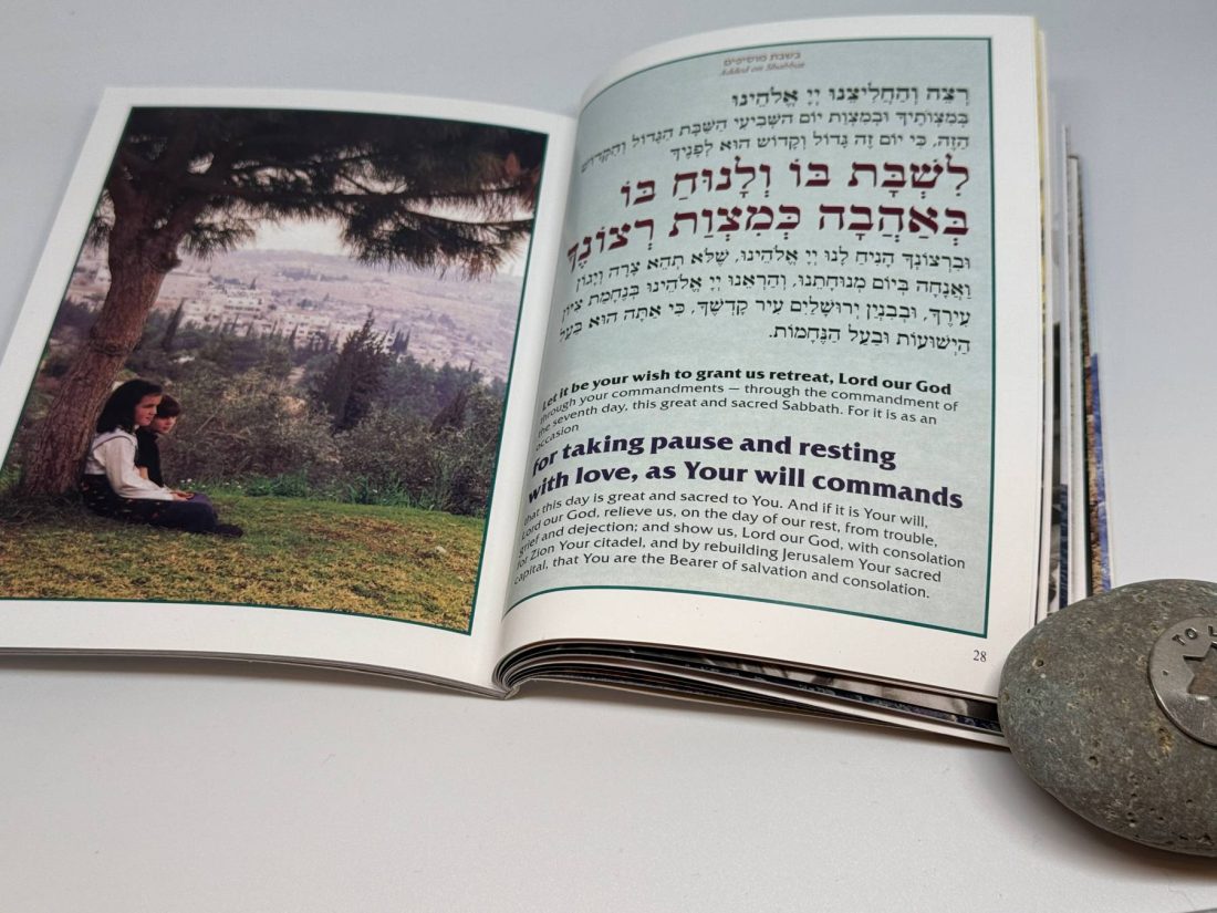 Hebrew-English Bencher with Stunning Visuals on Every Page This beautifully crafted bencher seamlessly blends tradition with artistry, featuring vibrant, full-page photographs that capture the essence of Jewish culture and the spirit of Israel. The carefully chosen images include scenes like children in Purim costumes, the lighting of the menorah during Hanukkah, and iconic Jerusalem views accompanying the Birkat HaMazon.