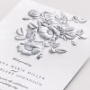 Guests will instantly appreciate the intricate detail of this deeply embossed Jewish wedding invitation. A delicately sketched floral motif adds depth and dimension, its subtle shading beautifully complementing the raised design. At the top, the Hebrew phrase Ani L'dodi V'dodi Li in Hebrew is elegantly displayed above the couple's English names in a stylish font, followed by their Hebrew names. The combination of modern design elements and fine embossed printing gives this invitation a sophisticated and contemporary flair.