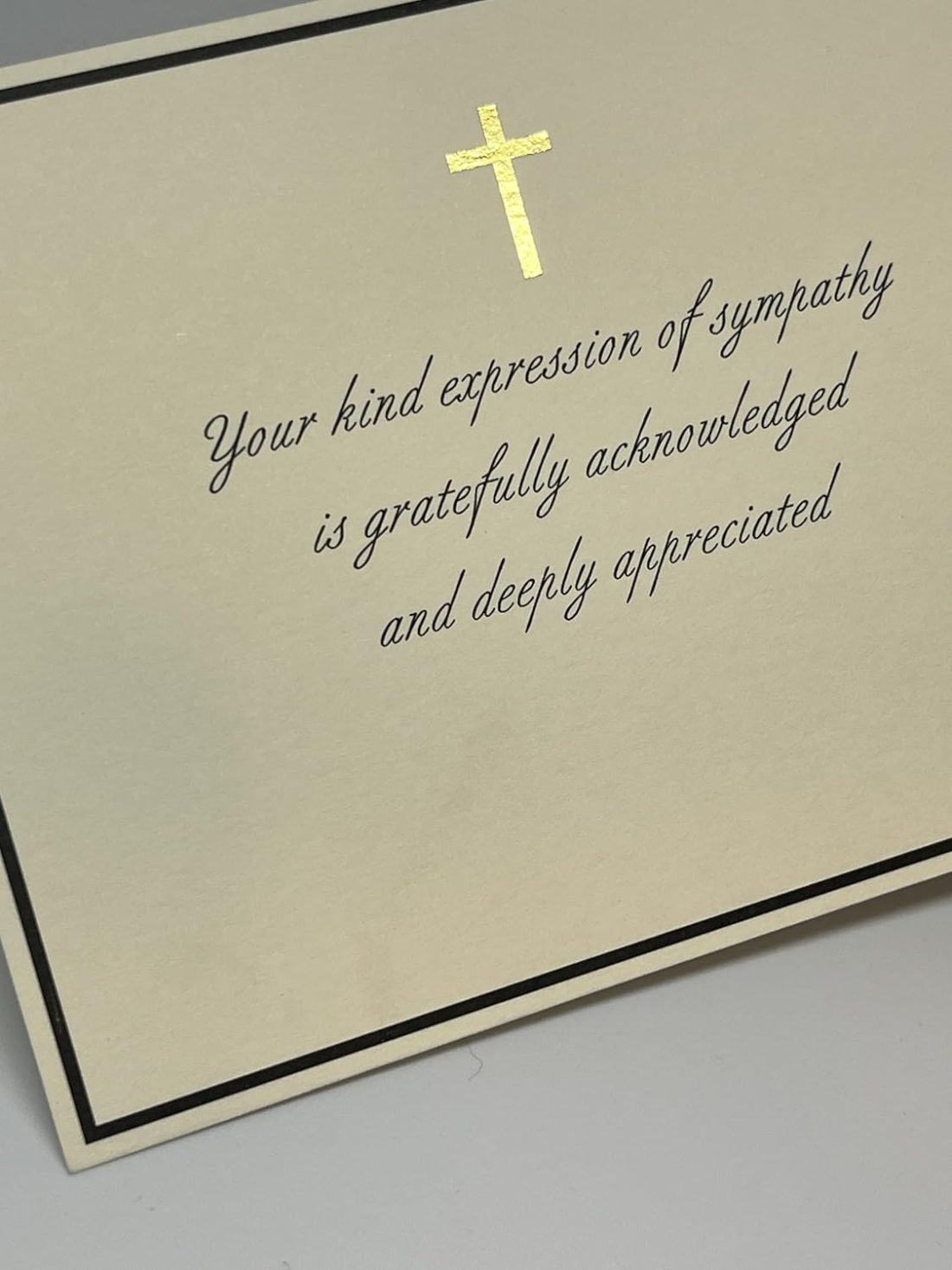 Our Christian Sympathy Thank You Cards provide a graceful and dignified way to acknowledge the kindness of friends and family during a difficult time. This design features a shimmering gold foil cross centered within a sophisticated black border, paired with an elegant script that reads, "Your kind expression of sympathy is gratefully acknowledged and deeply appreciated." Each card is printed on our signature 130lb. premium heavy ecru cardstock using professional presses to ensure a high-end, tactile feel. These are flat note cards, offering a clean and polished look for your personal acknowledgments.