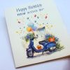 A charming bilingual birthday card featuring “Happy Birthday” in English and “יום הולדת שמח” (Yom Huledet Sameach) in Hebrew. The front design showcases a beautifully illustrated blue scooter adorned with flowers, colorful balloons, and a soft watercolor background. Perfect for sending warm birthday wishes with a unique artistic touch. Proudly 100% made in America *Jewish woman-owned * 5 cards and 5 matching envelopes Inside: Love and Happy Wishes for a wonderful Celebration, Mazal Tov מזל טוב
