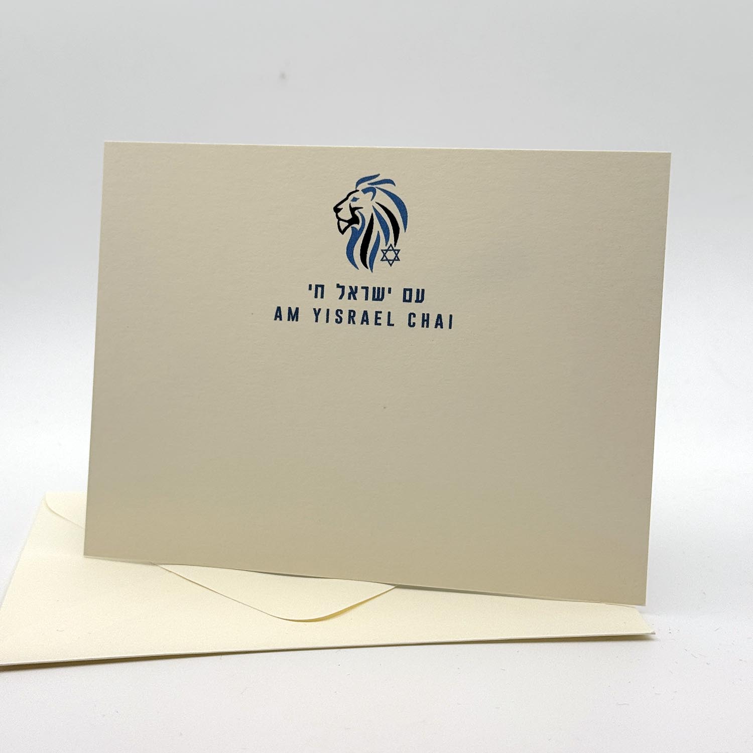 Cream-colored invitation card with navy blue lion head and Star of David logo, featuring Hebrew text and "AM YISRAEL CHAI" in English and Hebrew.