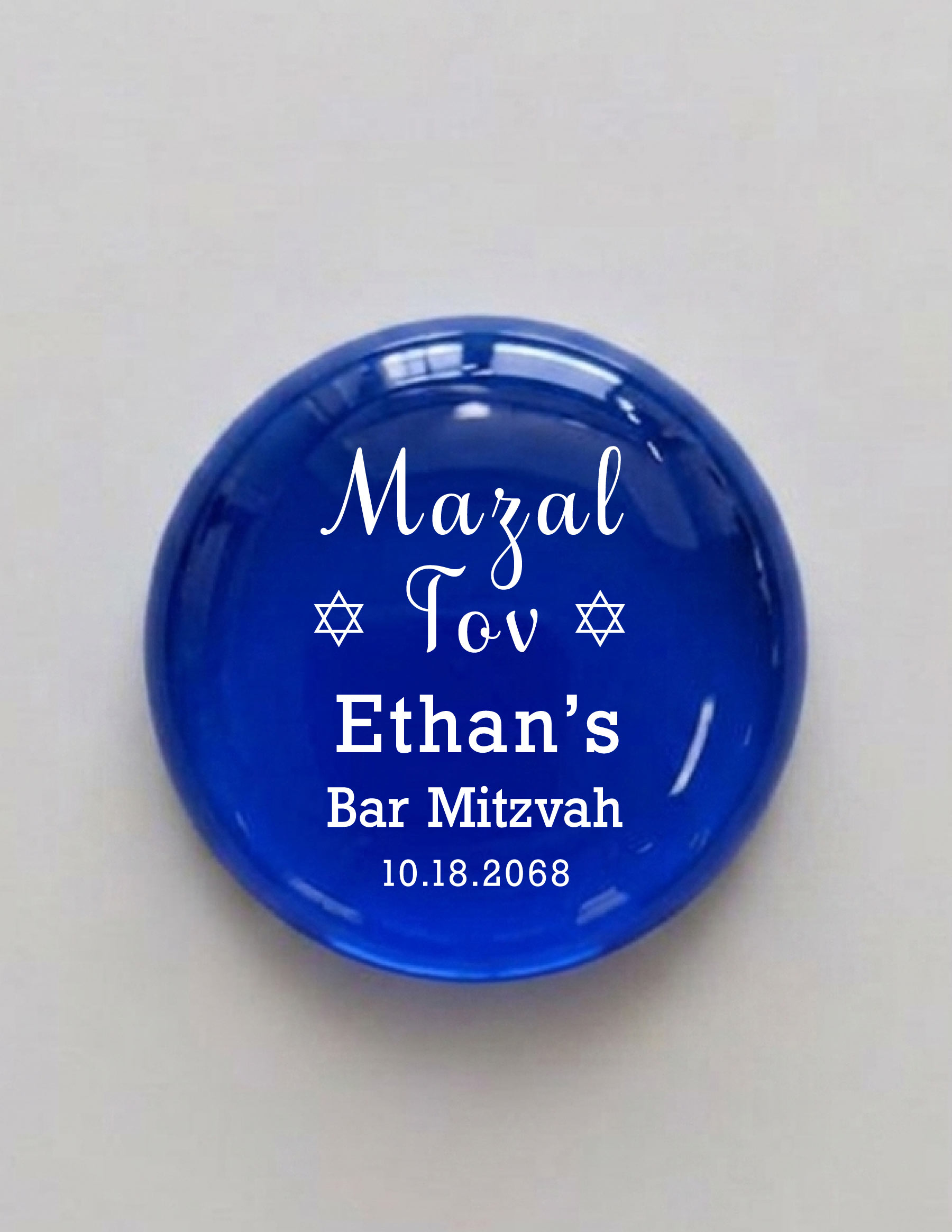 Mazal Tov Bar Mitzvah Printed Glass Stones, Mazal Tov — flanked by two Magen David, above the name and date, in clean white on rich translucent glass. A favor that reads as a keepsake, not a throwaway.