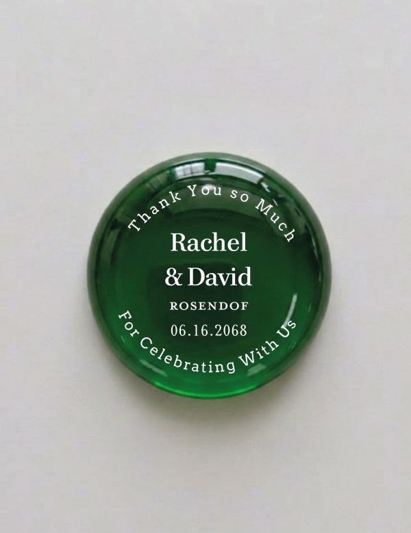 A keepsake favor your guests will actually keep. Each glass stone is personalized with your first names, last name, and wedding date, framed by an elegant circular "Thank You so Much / For Celebrating With Us" border.